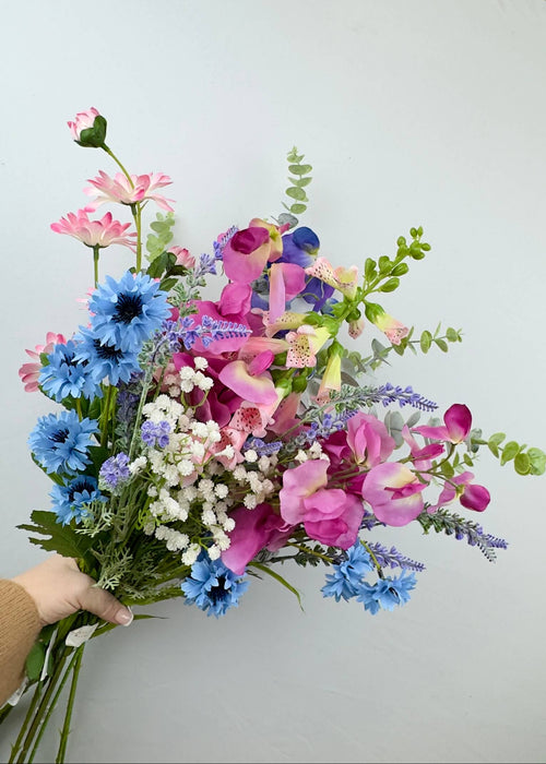 Country Cottage flower bouquet of cornflower blues and pinks with sweat peas, foxgloves and lavender with eucalyptus made from faux flowers and artificial foliage.